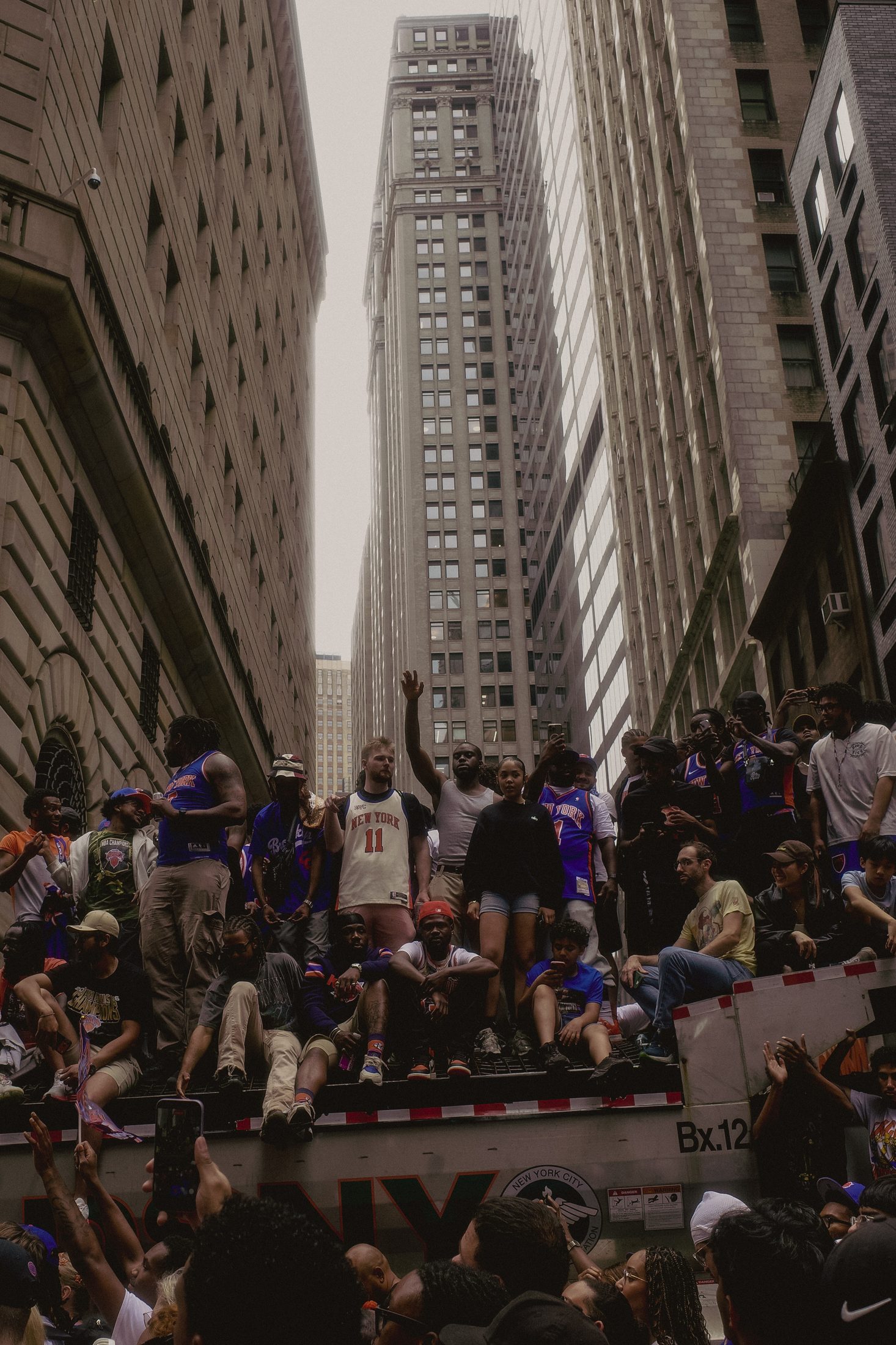 Crowd celebrating on top of a truck during the Knicks championship parade