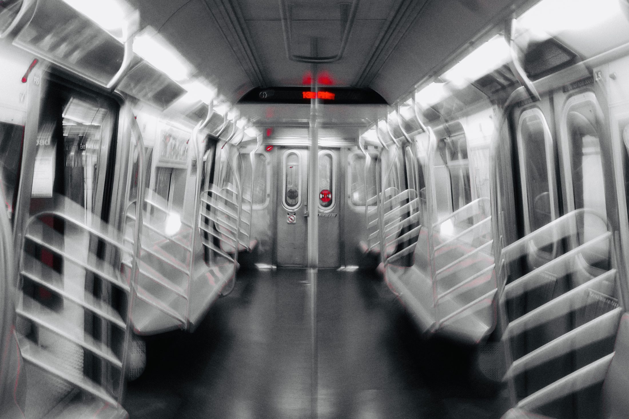 Empty NYC subway car, black and white with red accents